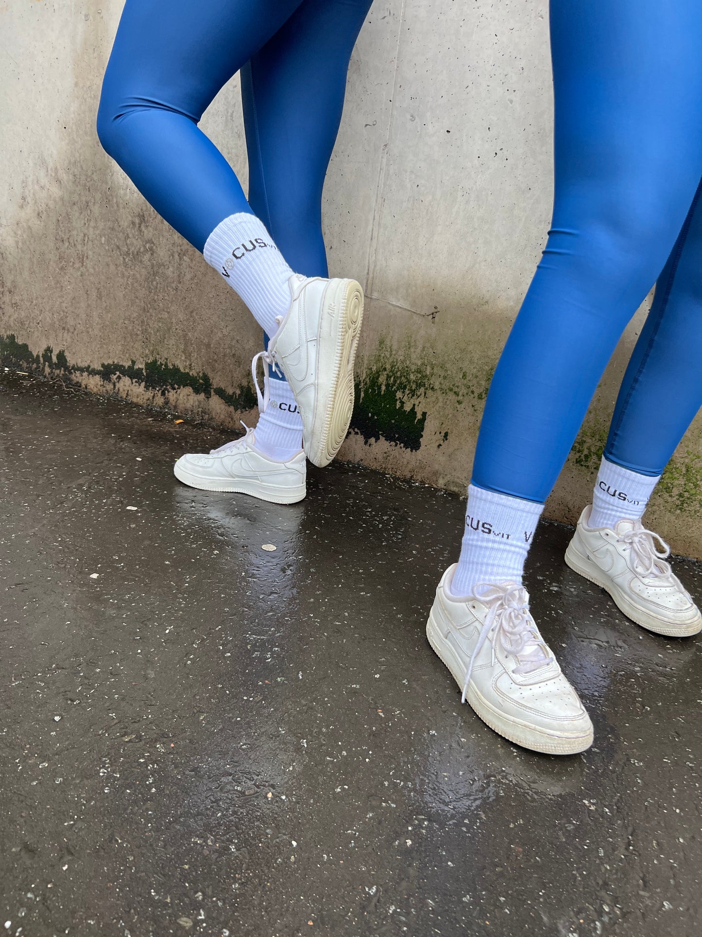 2 girls legs, They are wearing blue Vocus Vit leggings and crew socks and white trainers. Vocus vit is a sustainable women's activewear brand that uses recycled materials and ethical manufacturing. Based in Northern Ireland. Shipping worldwide.